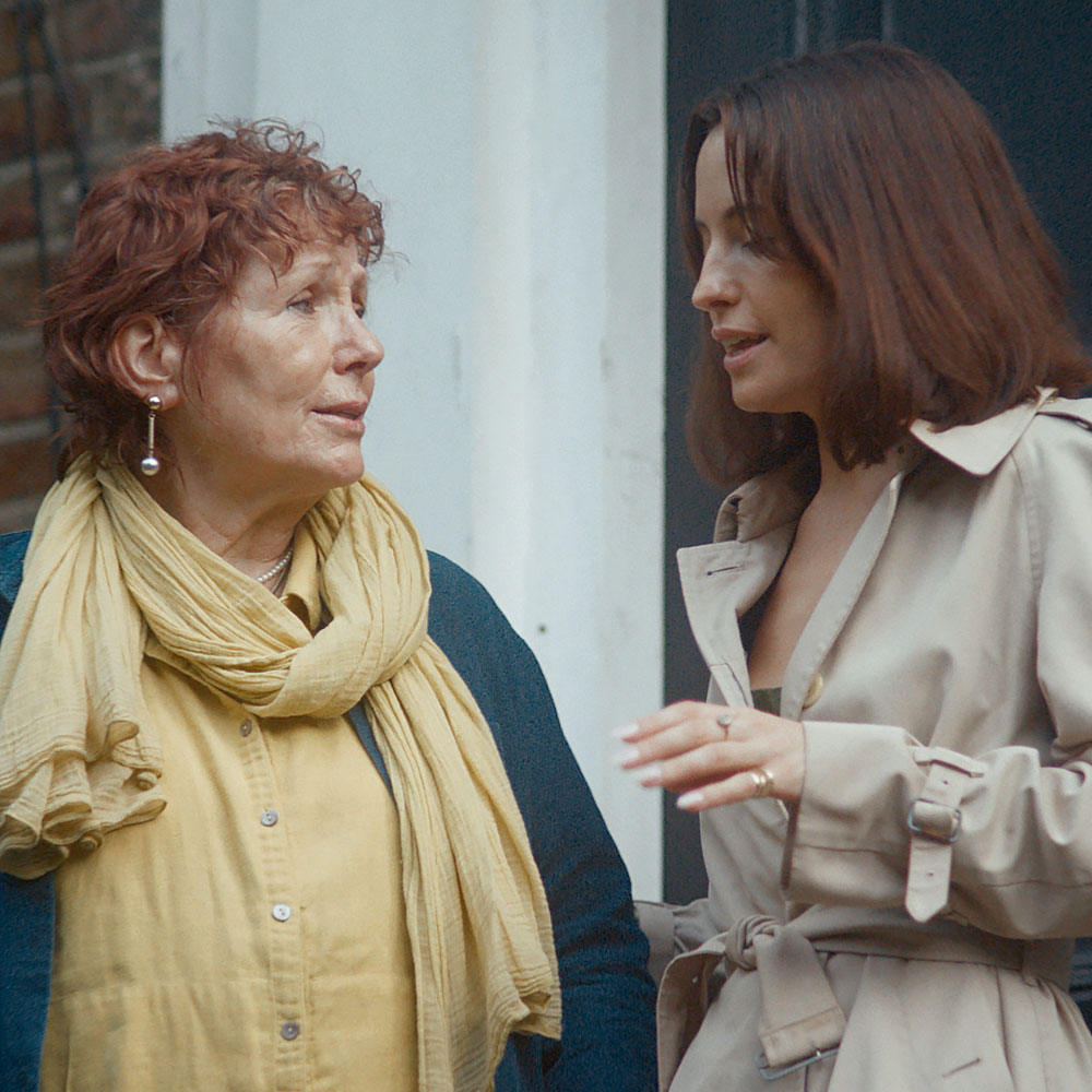 A woman talks with her mother as they leave the house. A woman talks with her mother as they leave the house.
